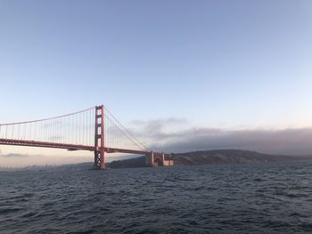 View of suspension bridge over sea