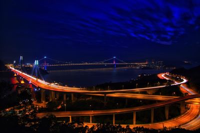 High angle view of light trails on bridge at night