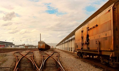 Railroad track against cloudy sky