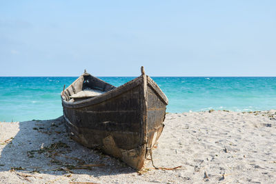 An old boat on the sand at tuzla with the black sea on background