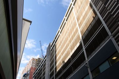 Low angle view of modern buildings against sky