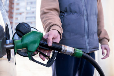 Midsection of man repairing car