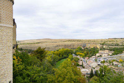 Scenic view of landscape and buildings against sky