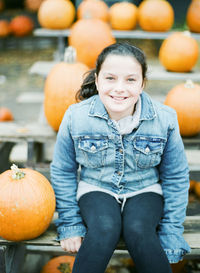 Portrait of smiling boy with pumpkins