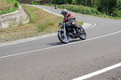 Man riding motorcycle on road