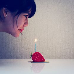 Woman blowing birthday candle