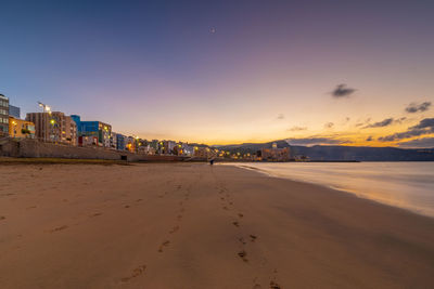 Scenic view of beach against sky during sunset