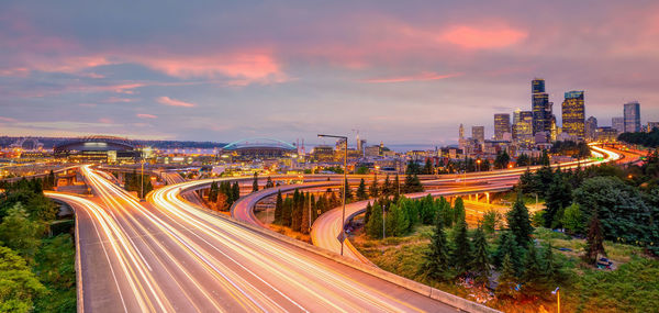 High angle view of illuminated cityscape against sky during sunset