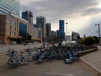 Bicycles on street against buildings in city