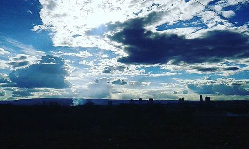 Scenic view of landscape against cloudy sky