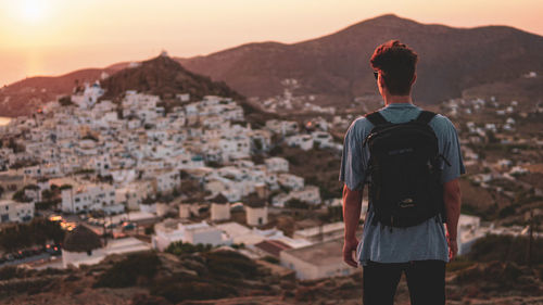 Rear view of man looking at cityscape