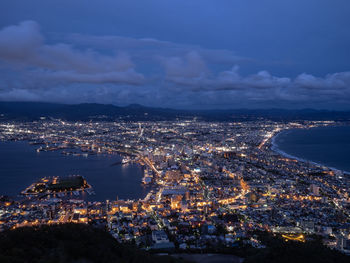 High angle view of illuminated cityscape against sky