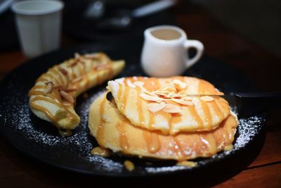 Close-up of pancakes served in plate on table