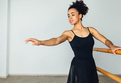 Young woman looking away while exercising in gym