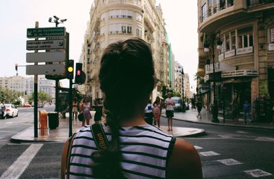 Rear view of man walking on road