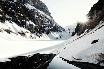 Scenic view of snow covered mountains against sky