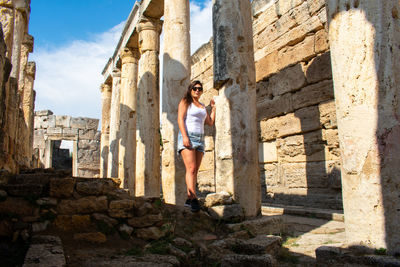 Full length of woman standing in old ruin