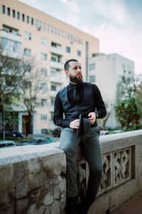 Young man looking away in city