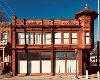 Low angle view of building against clear blue sky