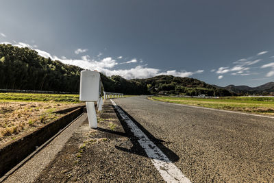 Empty road against sky