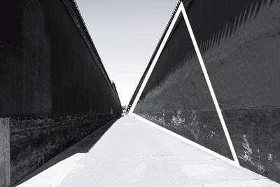 Road amidst buildings against sky