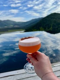 Cropped hand holding drink