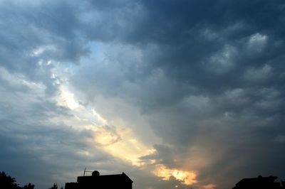 Low angle view of silhouette building against sky
