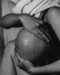 Close-up of woman holding coconut outdoors