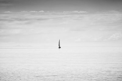 Sailboat in sea against sky