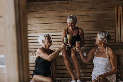 Happy female friends in sauna