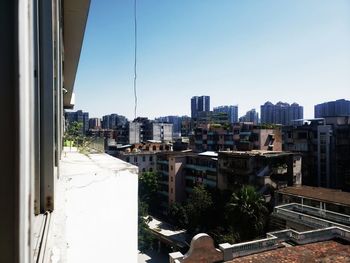 Buildings in city against clear sky