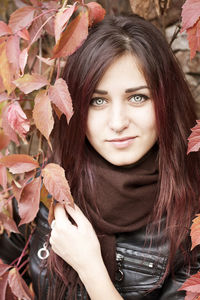 Portrait of beautiful young woman with leaves