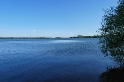 Scenic view of sea against blue sky