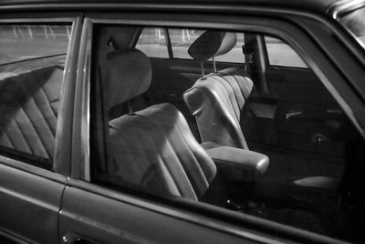 Midsection of woman sitting in car