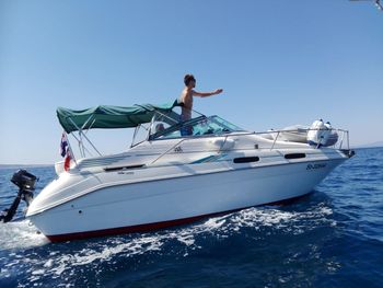 Nautical vessel on sea against clear blue sky