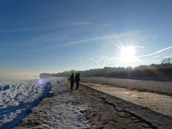 People standing at beach during winter