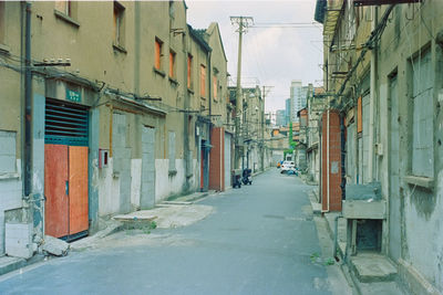 Empty alley amidst buildings in city