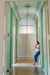Full length of woman at entrance of building