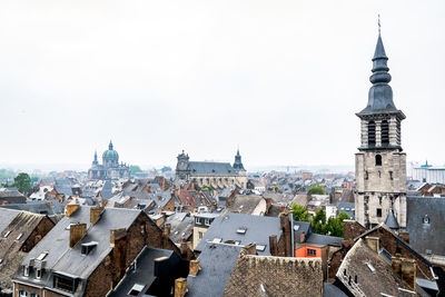 Buildings in city against clear sky