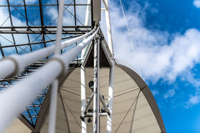 Low angle view of metallic built structure against sky