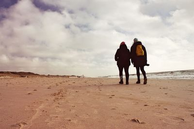 Rear view of people on beach