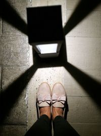 Low section of woman standing on floor