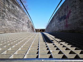 Surface level of footpath against clear sky