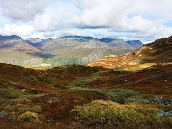 Scenic view of mountains against cloudy sky