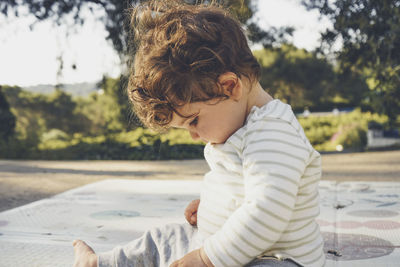 Side view of boy looking at camera