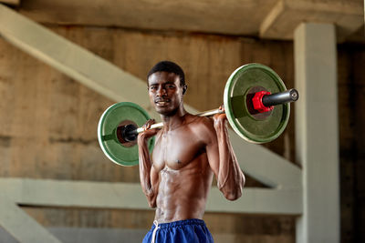 Portrait of young woman exercising in gym