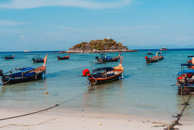 Boats in sea against sky