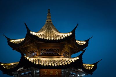 Low angle view of temple against clear blue sky