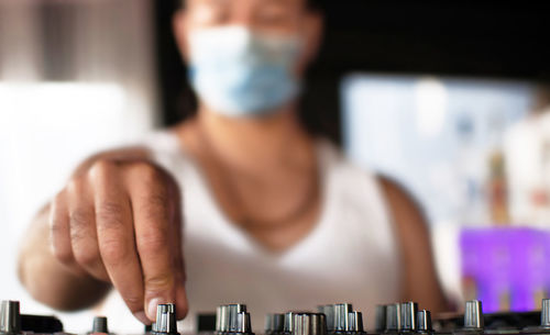 Close-up of man playing piano on table
