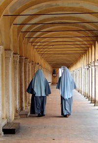 Rear view of nuns in corridor